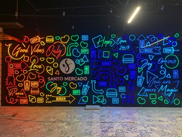 Mural de neón multicolor integrado a un ambiente comercial